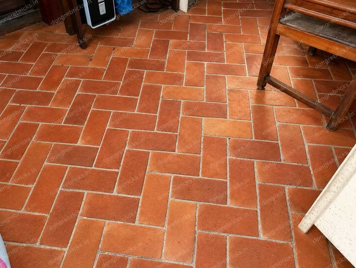 Interior terracotta floor tiles laid herringbone